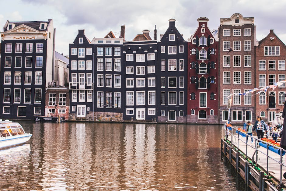 Beautiful view of historic Amsterdam canal houses with reflections on the water.