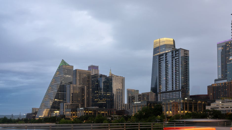 Stunning view of Austin's skyline at dusk with modern skyscrapers under a dramatic sky.