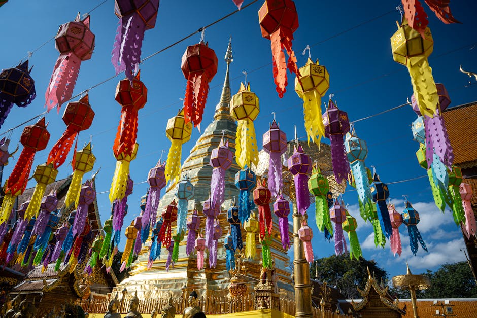 Vibrant lanterns adorn Wat Phra That Doi Suthep, showcasing Thai culture under a bright blue sky.