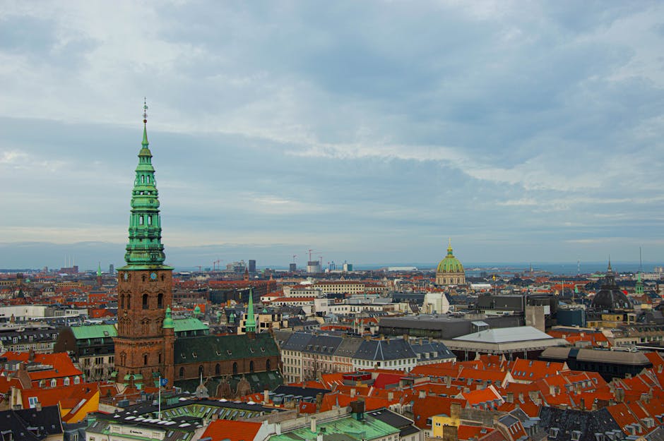 Stunning aerial view of Copenhagen showcasing historic architecture and urban landscape.