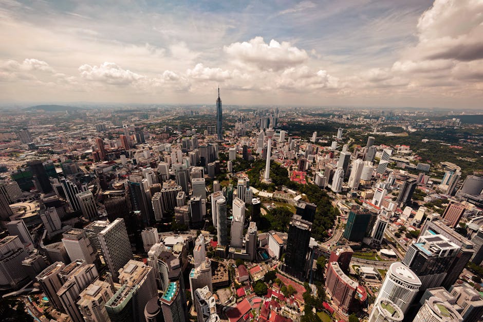 Stunning aerial view of Kuala Lumpur's cityscape featuring iconic skyscrapers and lush greenery.