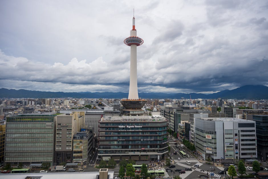 Explore the iconic Kyoto Tower surrounded by scenic urban landscapes in the heart of Kyoto, Japan.