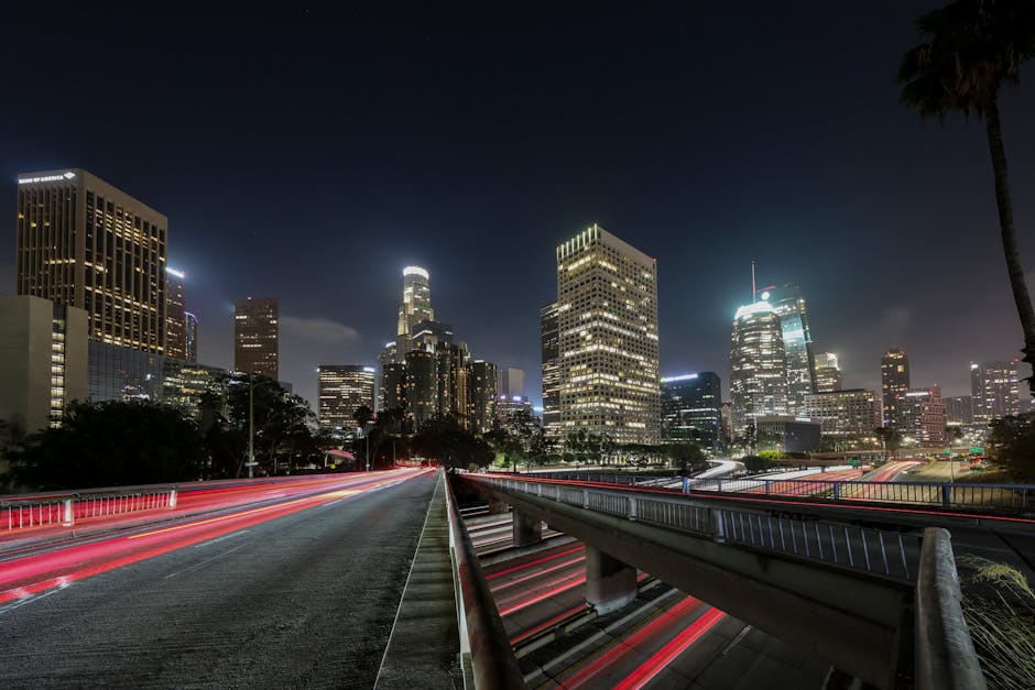 Vibrant long exposure of Downtown Los Angeles skyscrapers at night, showcasing the city skyline.