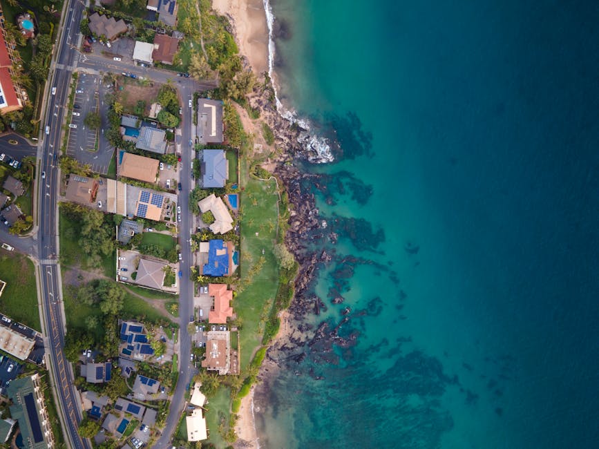 Stunning aerial view of Kihei, Hawaii coastline with turquoise waters and residential area.