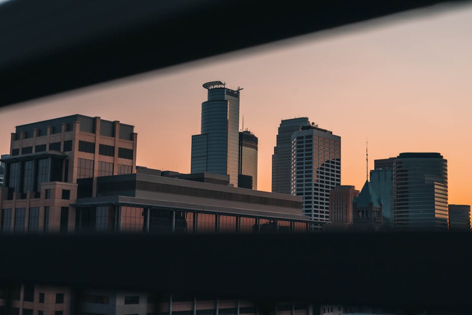 Captivating view of Minneapolis skyline during sunset, showcasing modern architecture in a serene twilight.