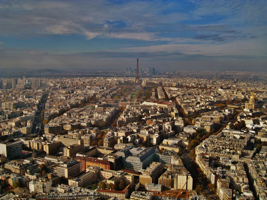Stunning aerial view of Paris featuring the iconic Eiffel Tower and urban landscape.
