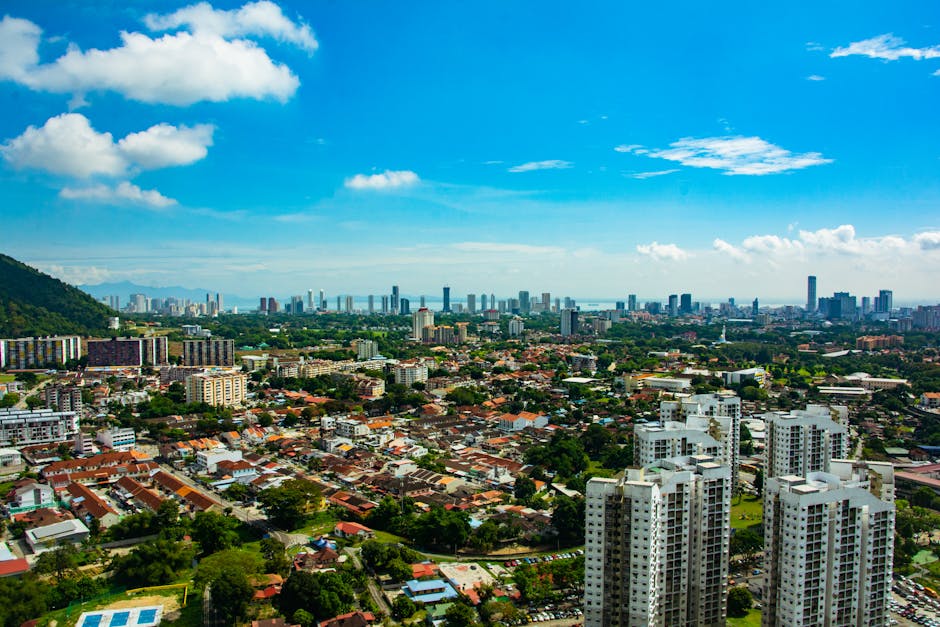 Panoramic view of George Town, Penang with urban skyline and blue sky.
