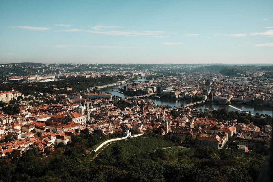 Stunning aerial vista of Prague showcasing the iconic Charles Bridge and Vltava River in the heart of the city.