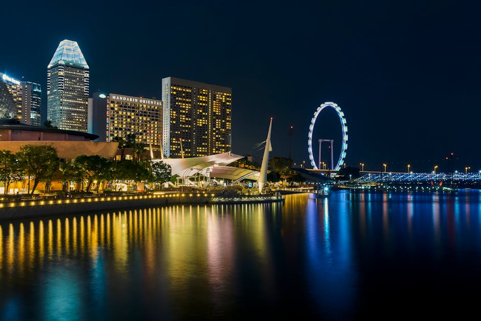 Stunning nighttime view of Singapore's skyline, featuring illuminated Marina Bay architecture and city lights reflection.