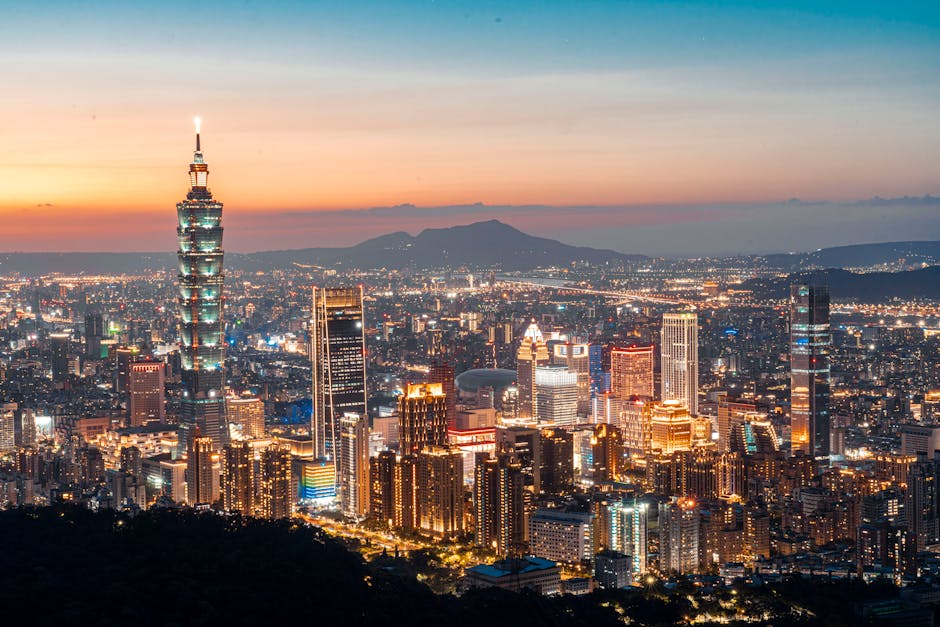 Dazzling view of Taipei city with illuminated skyline and landmarks at sunset.